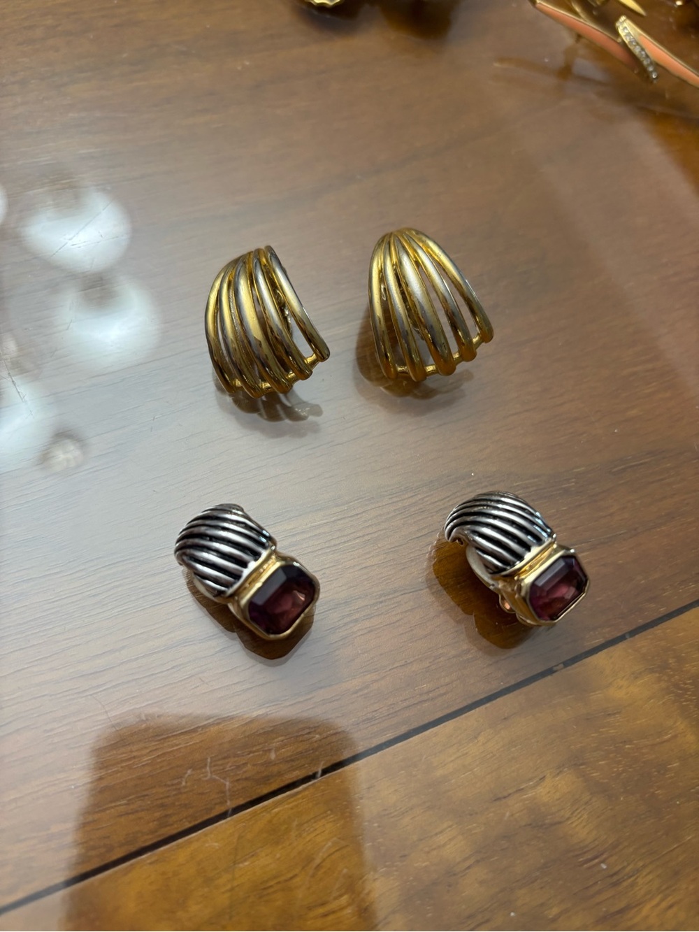 Clip on earrings.  Gold colored fan and designer inspired with purple stones
